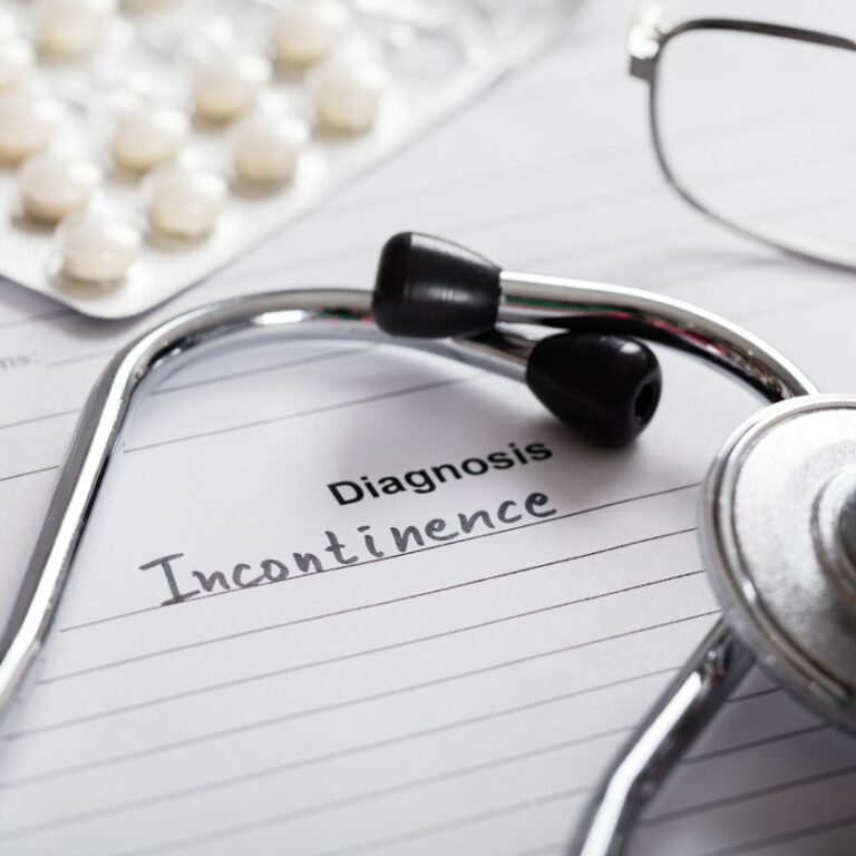Close-up Of Diagnosis Incontinence Word And Medical Composition On Paper