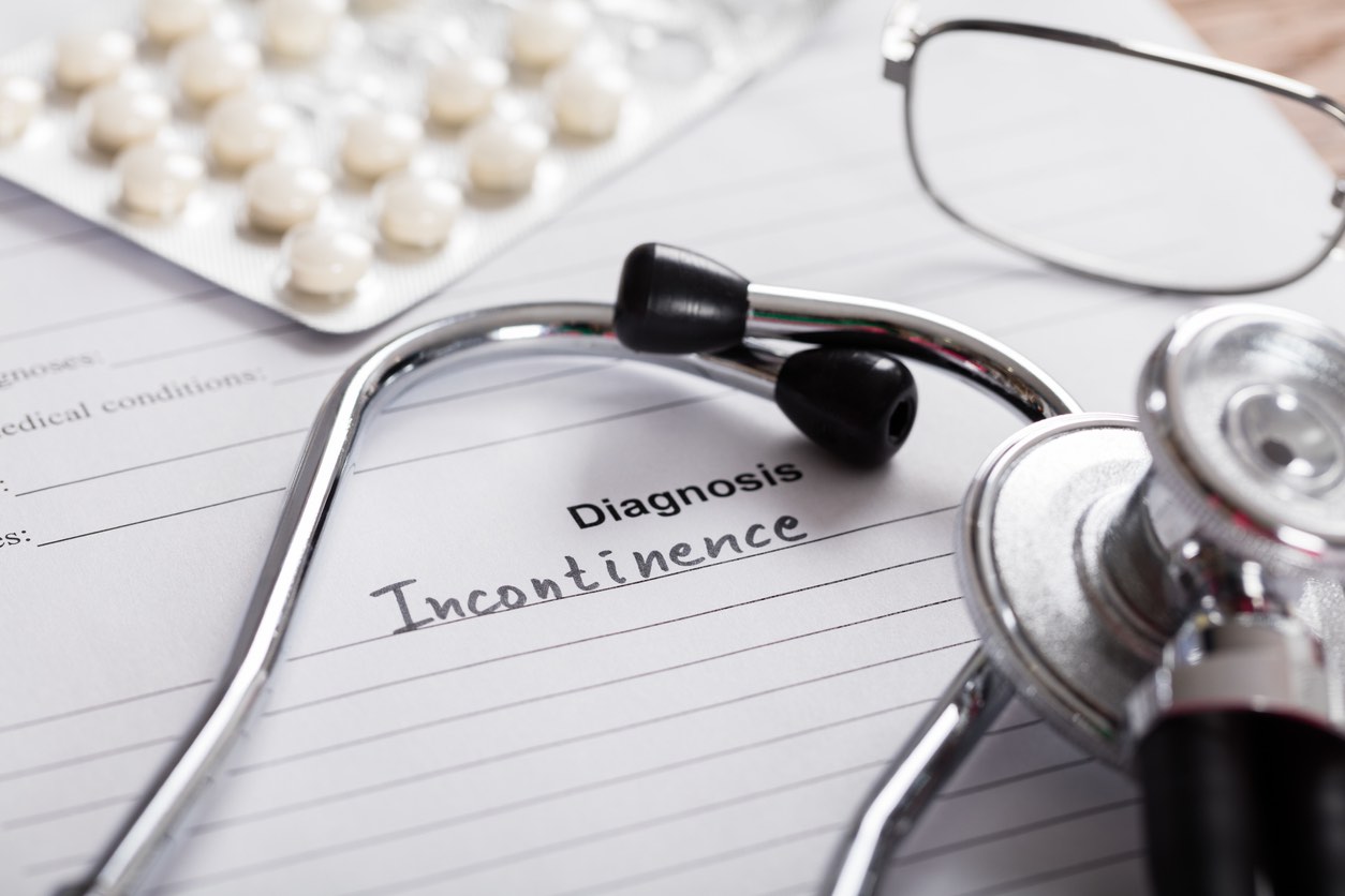 Close-up Of Diagnosis Incontinence Word And Medical Composition On Paper