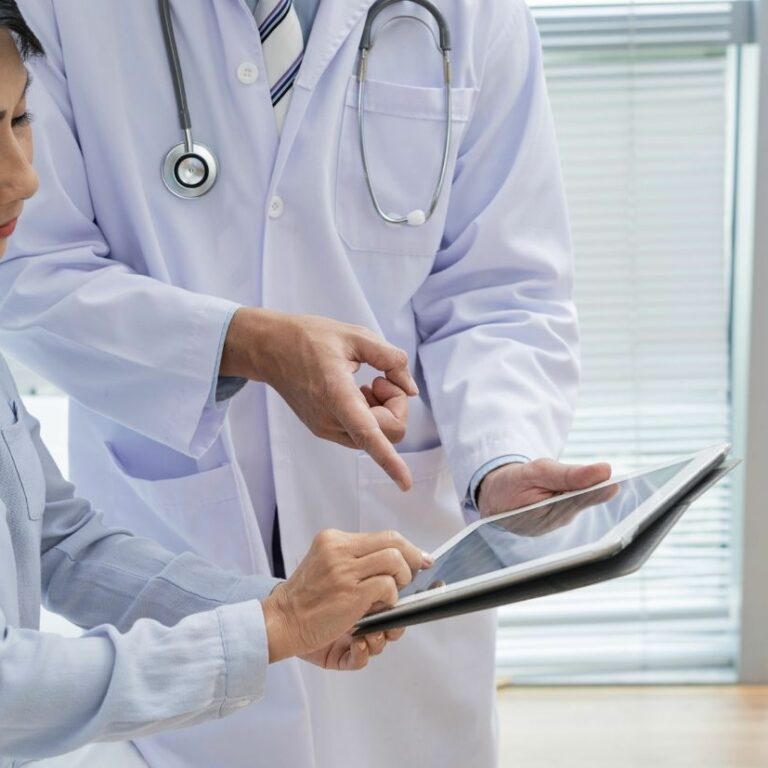 doctors looking at a tablet