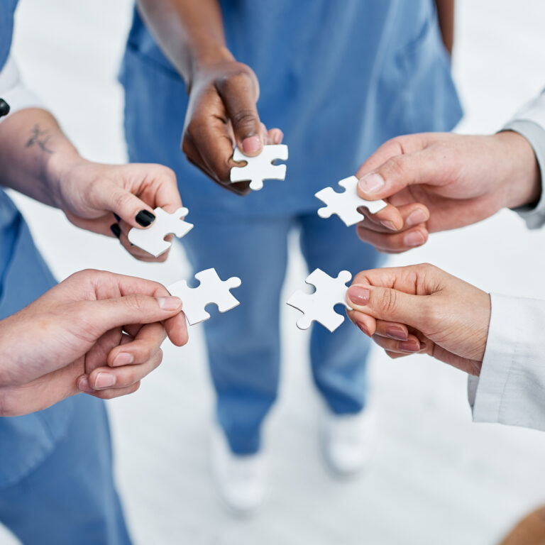 medical workers holding puzzle pieces
